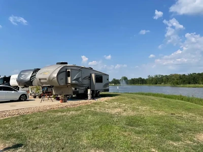 RV on concrete next to a grass lawn